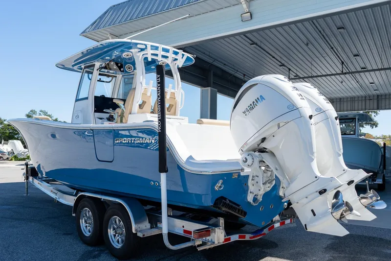 Slide: The Image of 2026 Sportsman Open 282 Center Console boat with dual Yamaha engines on a trailer. - 8