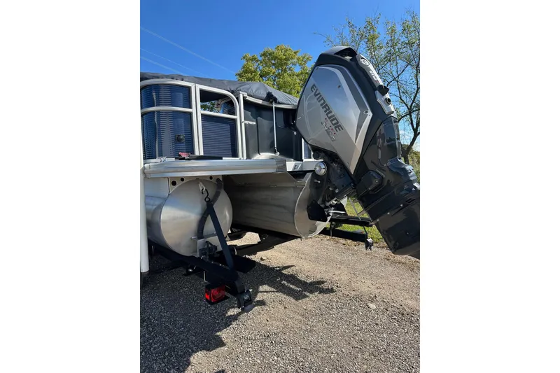 Slide: The Image of 2019 Bennington SX 22 Fishing boat with Evinrude outboard motor, parked on gravel. - 12