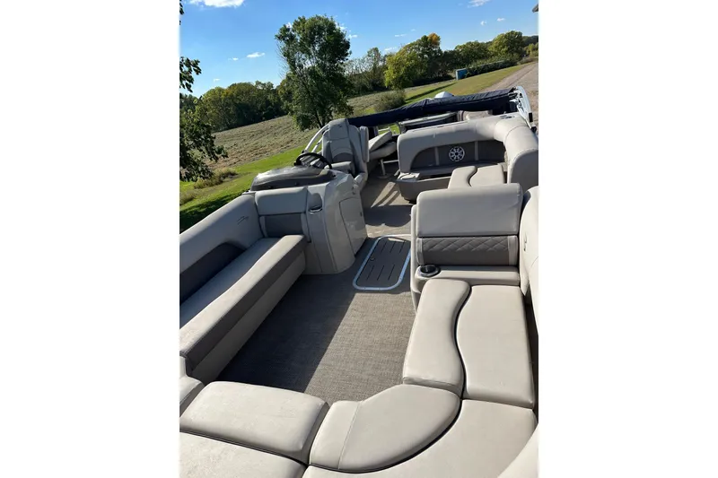 Slide: The Image of 2019 Bennington SX 22 Fishing boat interior with spacious seating and scenic outdoor view. - 14
