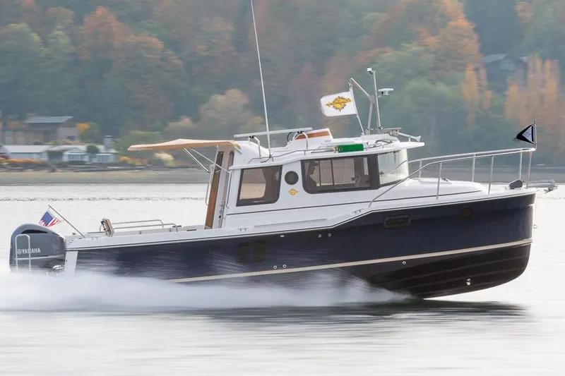 The Image of Manufacturer Provided Image: 2025 Ranger Tugs R-25 cruising on a calm lake with autumn foliage. - 0