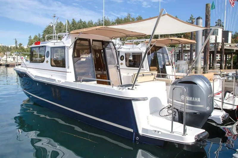 Slide: The Image of Manufacturer Provided Image: 2025 Ranger Tugs R-25 boat docked with Yamaha engine, featuring a sleek design. - 4