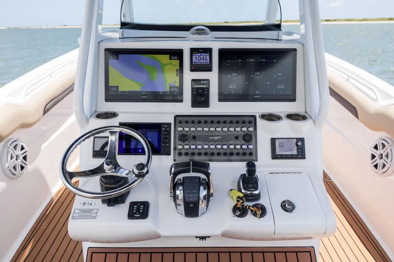 Slide: The Image of 2020 Tidewater 320 CC Adventure boat dashboard with advanced navigation and control systems. - 21
