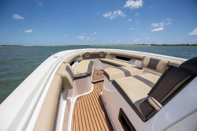 Slide: The Image of 2020 Tidewater 320 CC Adventure boat interior with luxurious seating on open water. - 22