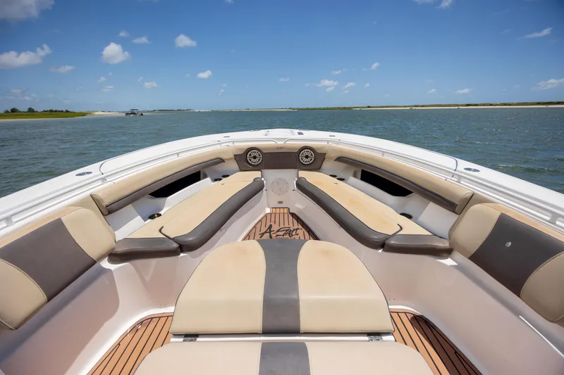 Slide: The Image of 2020 Tidewater 320 CC Adventure boat interior with cushioned seating on open water. - 23