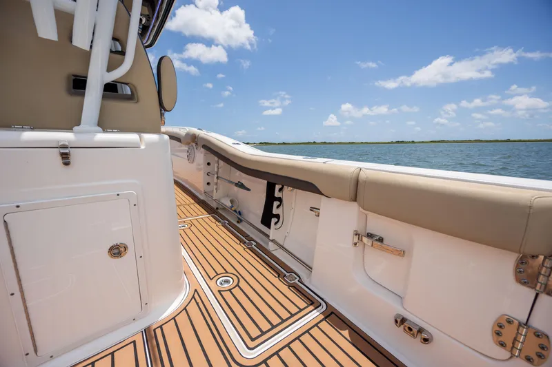 Slide: The Image of 2020 Tidewater 320 CC Adventure boat interior with teak flooring, ocean view, and clear sky. - 26