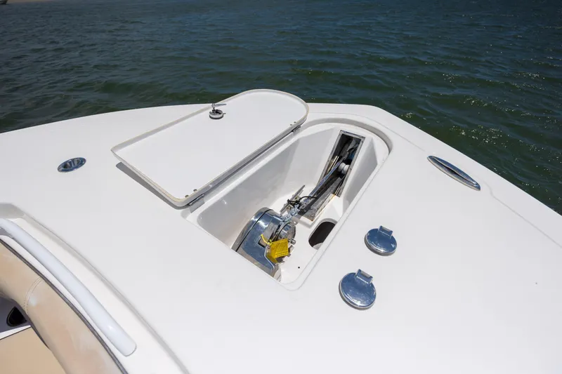 Slide: The Image of 2020 Tidewater 320 CC Adventure boat anchor compartment on open water. - 27