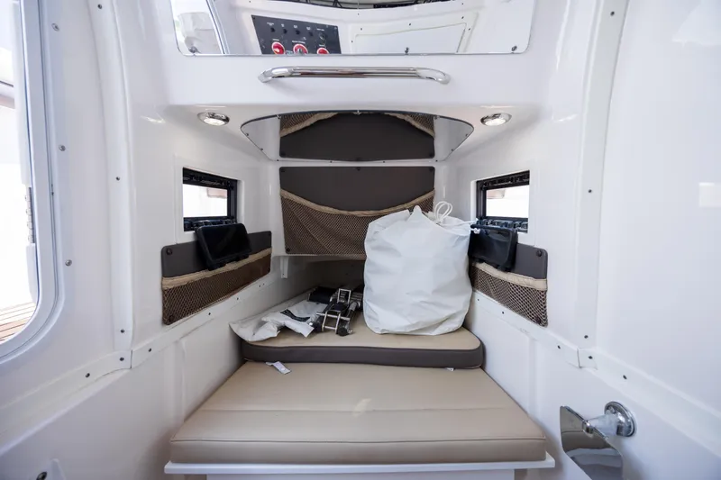 Slide: The Image of Interior cabin of 2020 Tidewater 320 CC Adventure boat, featuring seating and storage. - 30
