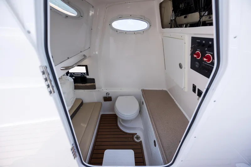 Slide: The Image of 2020 Tidewater 320 CC Adventure boat cabin with toilet and seating area. - 31