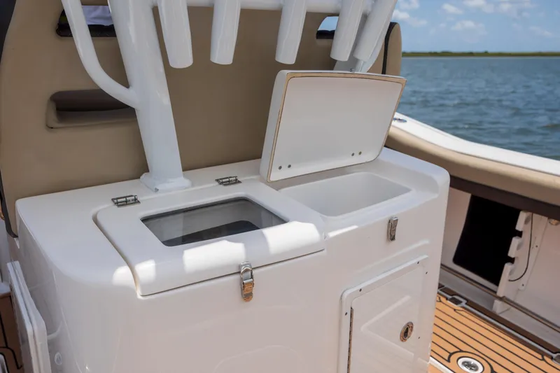 Slide: The Image of 2020 Tidewater 320 CC Adventure boat with open storage compartments on deck. - 33