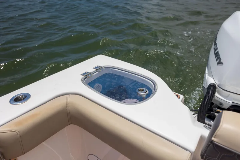 Slide: The Image of 2020 Tidewater 320 CC Adventure boat with livewell and Mercury engine on water. - 34