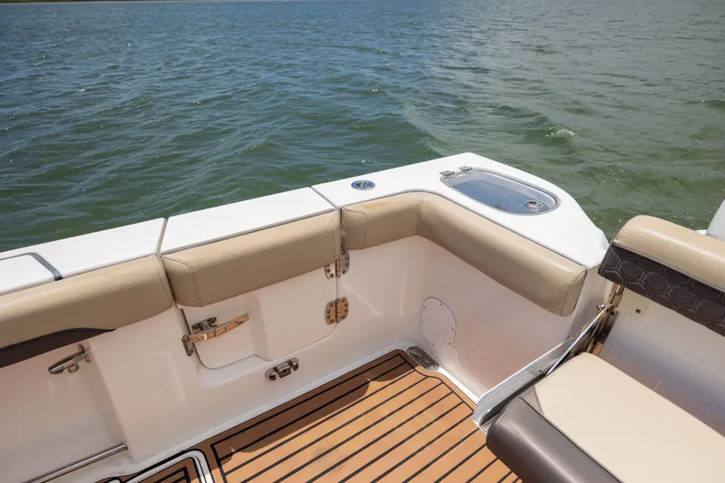 Slide: The Image of 2020 Tidewater 320 CC Adventure boat interior with cushioned seating and teak flooring. - 35