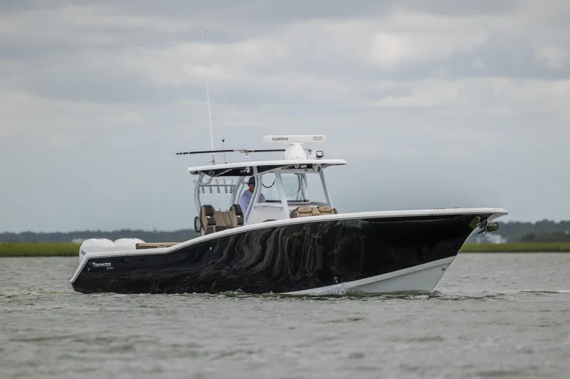 Slide: The Image of 2020 Tidewater 320 CC Adventure boat cruising on open water. - 6