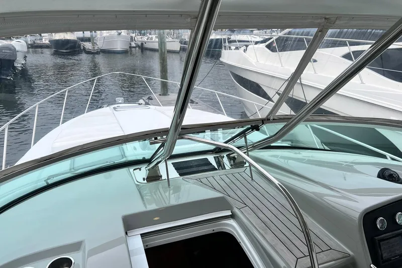 Slide: The Image of 2011 Formula 37 Performance Cruiser at marina, showcasing sleek design and spacious deck. - 11