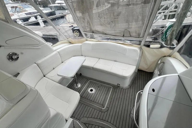 Slide: The Image of 2011 Formula 37 Performance Cruiser interior with white seating and table, docked at marina. - 13