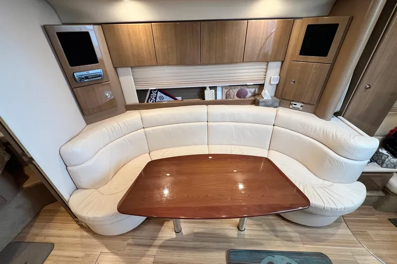 Slide: The Image of Luxurious interior of 2011 Formula 37 Performance Cruiser with curved seating and wooden table. - 22