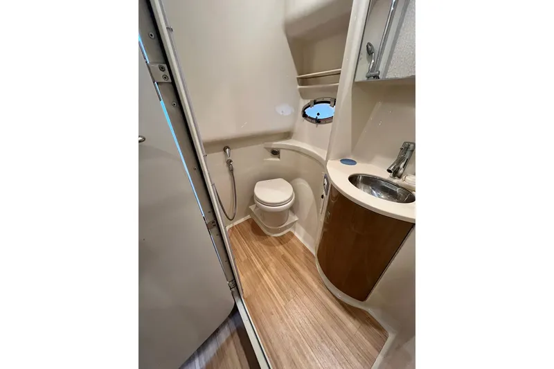 Slide: The Image of 2011 Formula 37 Performance Cruiser bathroom with toilet, sink, and wooden flooring. - 27