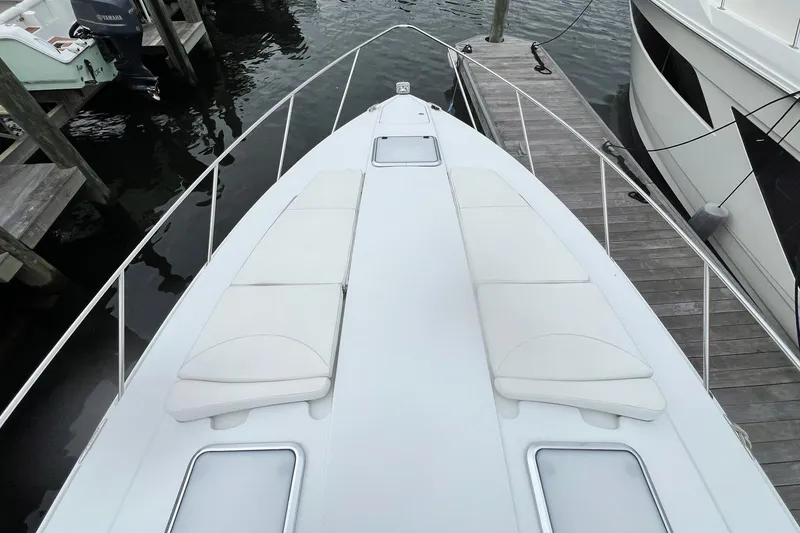 Slide: The Image of 2011 Formula 37 Performance Cruiser docked, featuring spacious deck with white seating. - 32