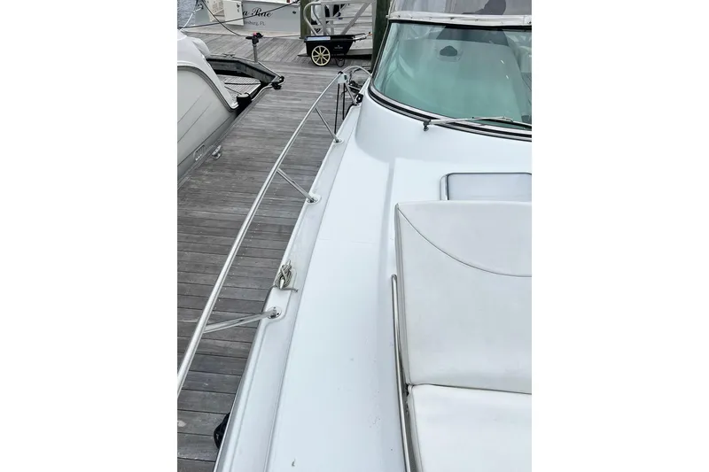 Slide: The Image of 2011 Formula 37 Performance Cruiser docked, showcasing sleek deck and railing design. - 37