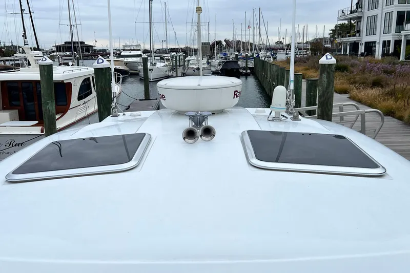 Slide: The Image of 2011 Formula 37 Performance Cruiser docked at marina, showcasing deck and hatches. - 38