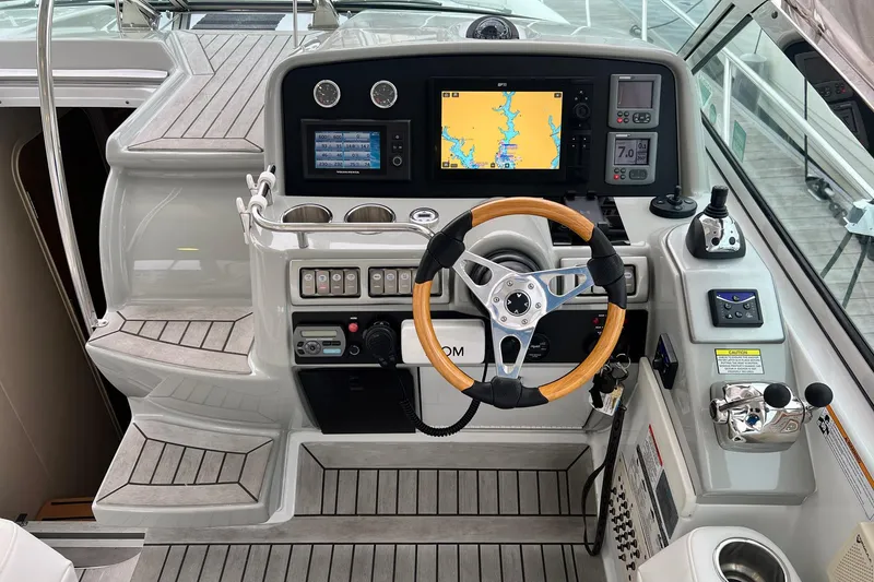 Slide: The Image of 2011 Formula 37 Performance Cruiser helm with navigation screens and wooden steering wheel. - 9