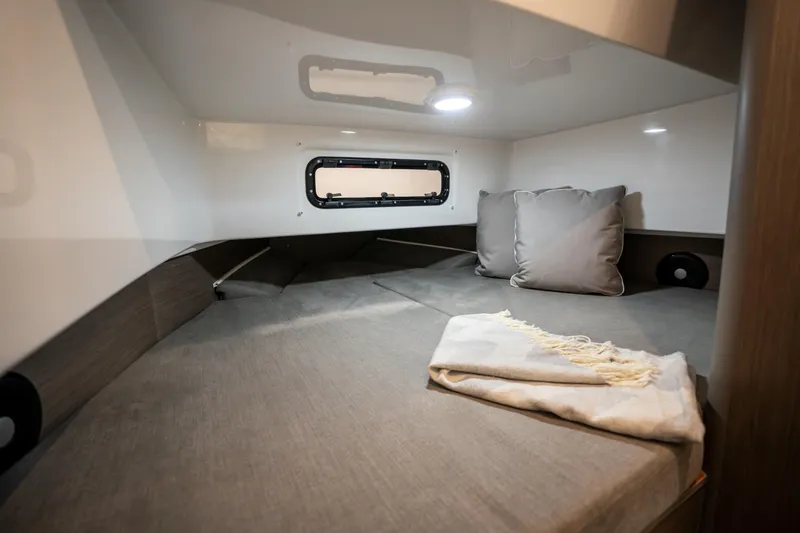 Slide: The Image of 2025 Beneteau Flyer 9 SPACEdeck cabin interior with cozy bedding and window. - 10