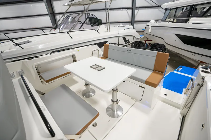 Slide: The Image of 2025 Beneteau Flyer 9 SPACEdeck interior with seating and table in a showroom. - 13