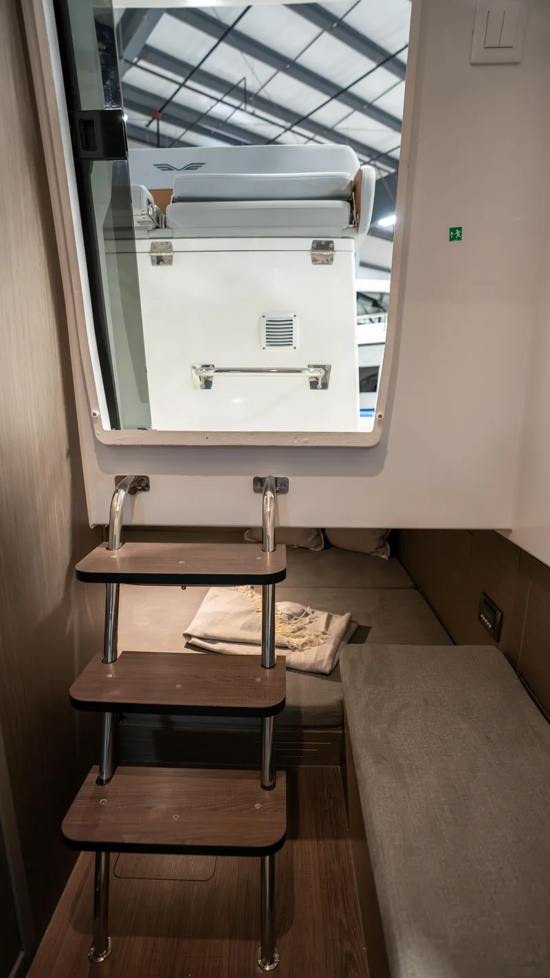 Slide: The Image of Interior view of 2025 Beneteau Flyer 9 SPACEdeck with compact cabin stairs. - 9