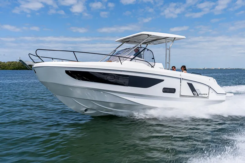 The Image of 2025 Beneteau Flyer 9 SUNdeck cruising on open water under a clear blue sky. - 0