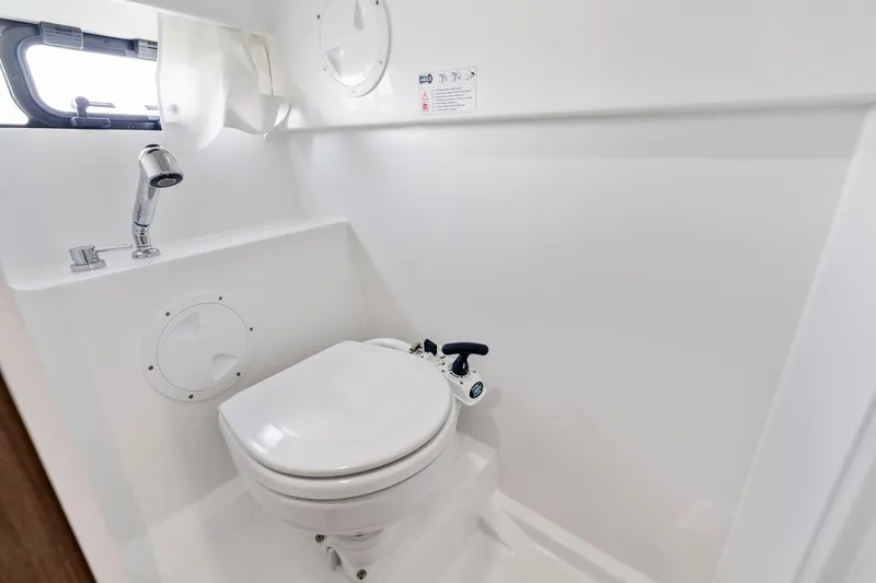 Slide: The Image of 2025 Beneteau Flyer 9 SUNdeck bathroom with compact toilet and sink. - 17