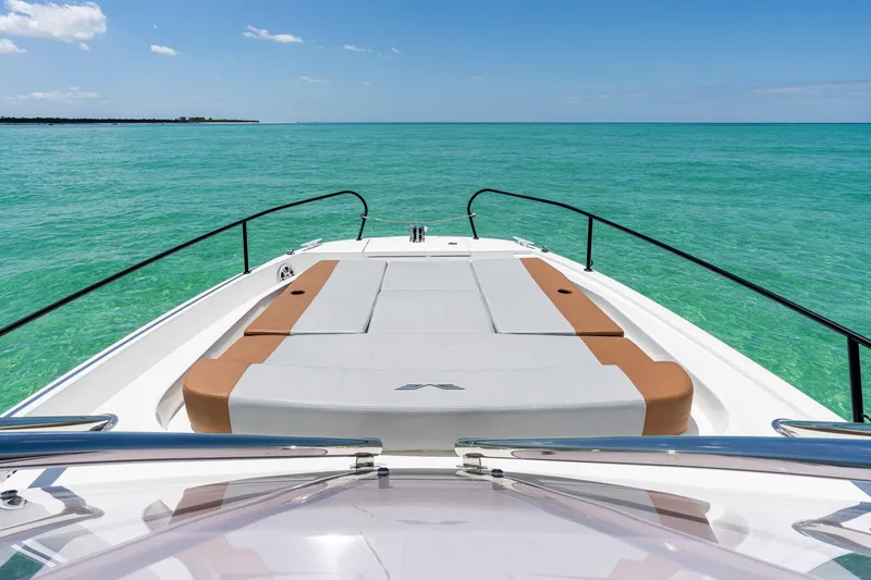 Slide: The Image of 2025 Beneteau Flyer 9 SUNdeck on turquoise water, showcasing spacious deck and sleek design. - 18
