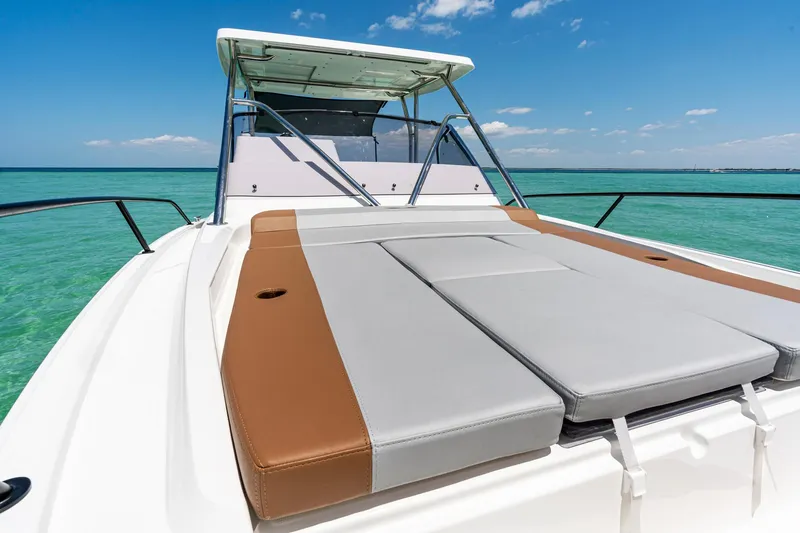 Slide: The Image of 2025 Beneteau Flyer 9 SUNdeck on turquoise water, featuring spacious sunbathing area. - 19