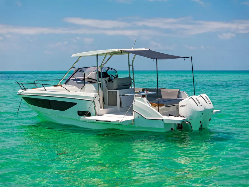 Slide: The Image of 2025 Beneteau Flyer 9 SUNdeck boat on turquoise water, featuring twin engines and sunshade. - 22