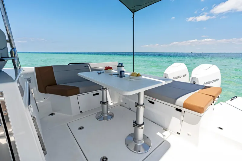 Slide: The Image of 2025 Beneteau Flyer 9 SUNdeck, spacious deck with seating, table, and ocean view. - 7