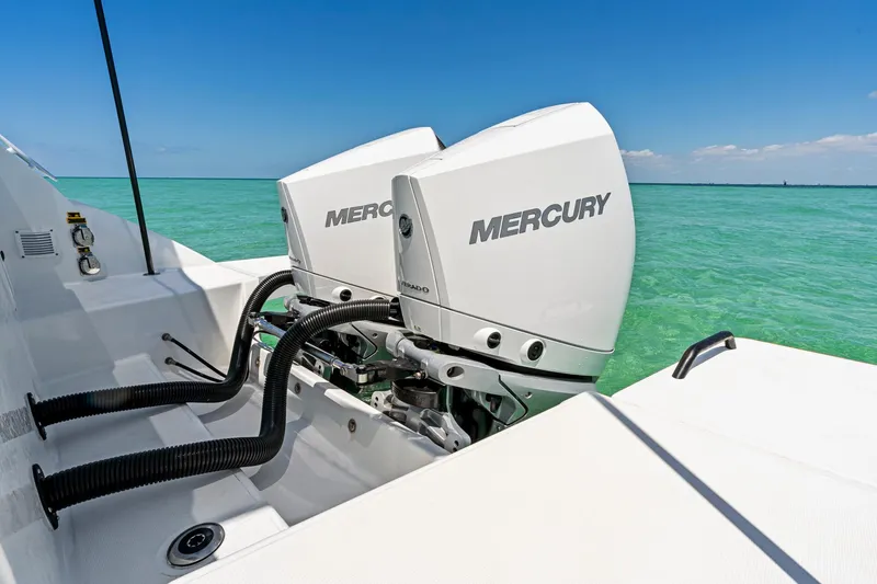Slide: The Image of 2025 Beneteau Flyer 9 SUNdeck with dual Mercury outboard engines on turquoise water. - 9