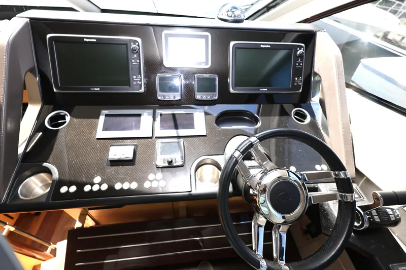 Slide: The Image of Helm of 2016 Sunseeker Manhattan 55 yacht with advanced navigation controls and displays. - 15