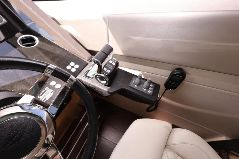 Slide: The Image of Helm controls of 2016 Sunseeker Manhattan 55 yacht with steering wheel and throttle. - 16