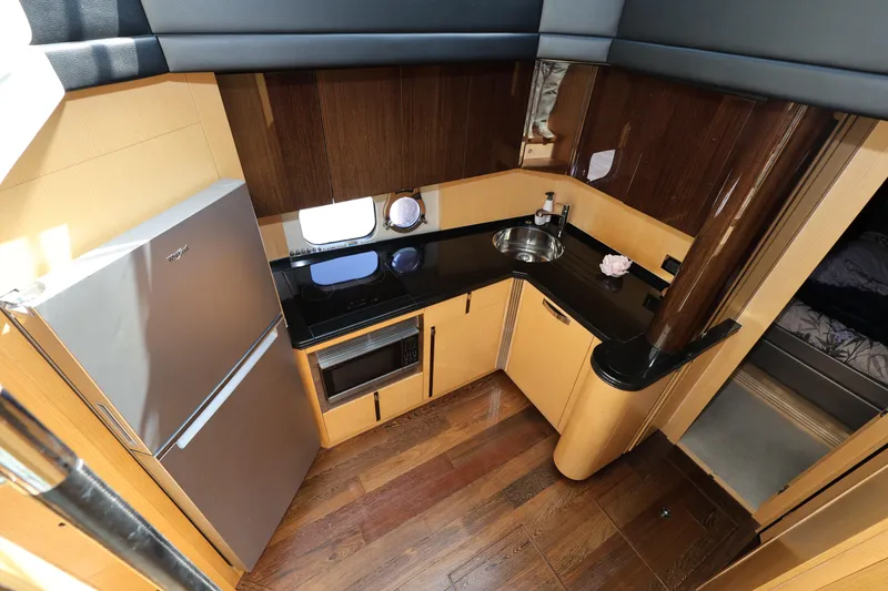 Slide: The Image of 2016 Sunseeker Manhattan 55 yacht kitchen with modern appliances and wood finish. - 18
