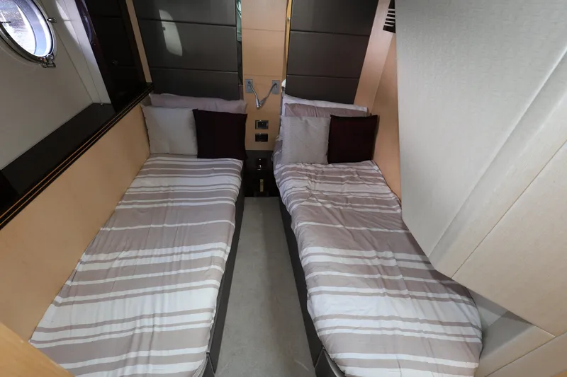 Slide: The Image of Twin cabin interior of 2016 Sunseeker Manhattan 55 yacht with striped bedding. - 23
