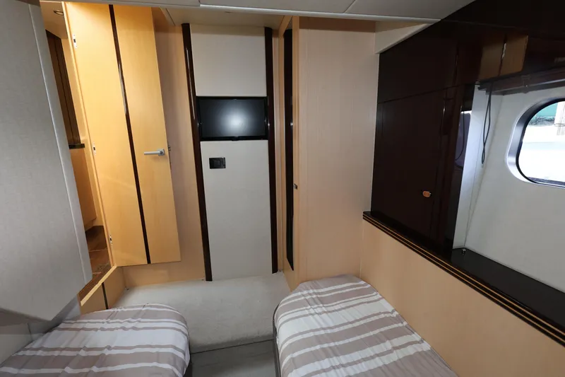 Slide: The Image of Interior of 2016 Sunseeker Manhattan 55 yacht cabin with twin beds and window. - 24