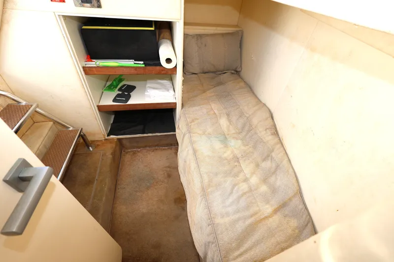 Slide: The Image of Small cabin interior of 2016 Sunseeker Manhattan 55 yacht with bed and storage shelves. - 29