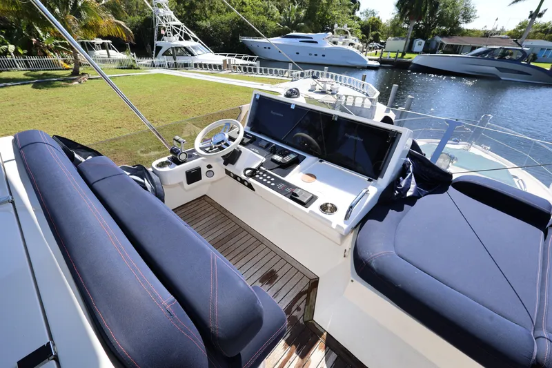 Slide: The Image of Flybridge of 2016 Sunseeker Manhattan 55 yacht with modern controls and seating. - 36