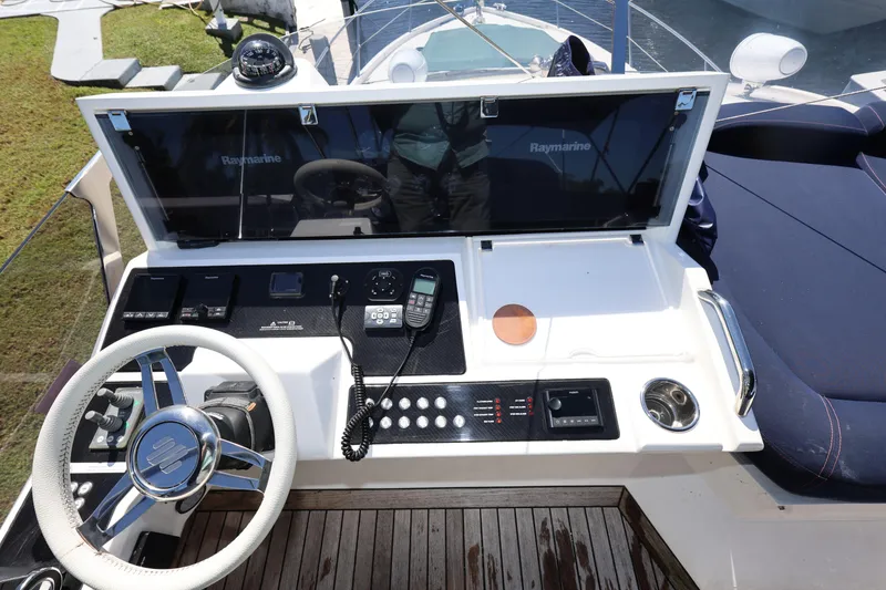 Slide: The Image of Control panel of 2016 Sunseeker Manhattan 55 yacht with steering wheel and navigation equipment. - 37