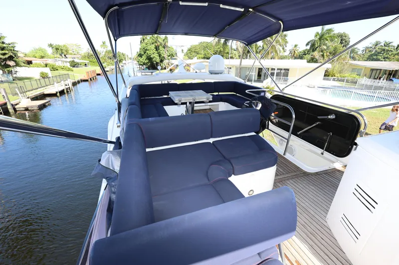 Slide: The Image of Luxurious 2016 Sunseeker Manhattan 55 yacht with spacious outdoor seating and scenic canal view. - 38