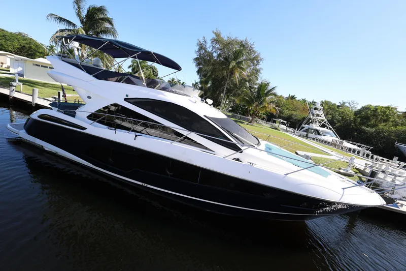 Slide: The Image of 2016 Sunseeker Manhattan 55 yacht docked by palm trees, sunny day. - 6