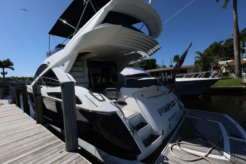 Slide: The Image of 2016 Sunseeker Manhattan 55 yacht docked, showcasing sleek design and luxury features. - 8