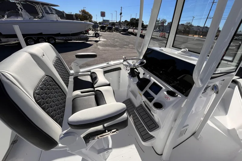 Slide: The Image of 2026 Tidewater 210 CC Adventure boat interior with modern helm and seating. - 12