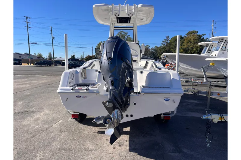 Slide: The Image of 2026 Tidewater 210 CC Adventure boat with powerful outboard motor, parked outdoors. - 3