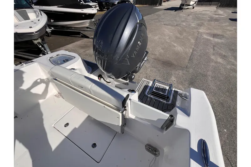Slide: The Image of 2026 Tidewater 210 CC Adventure boat with Yamaha outboard motor, rear seating, and swim platform. - 4