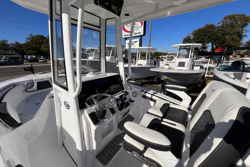 Slide: The Image of 2026 Tidewater 210 CC Adventure boat interior with modern helm and seating. - 6