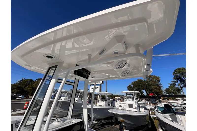 Slide: The Image of 2026 Tidewater 210 CC Adventure boat with T-top and speakers, displayed outdoors. - 7